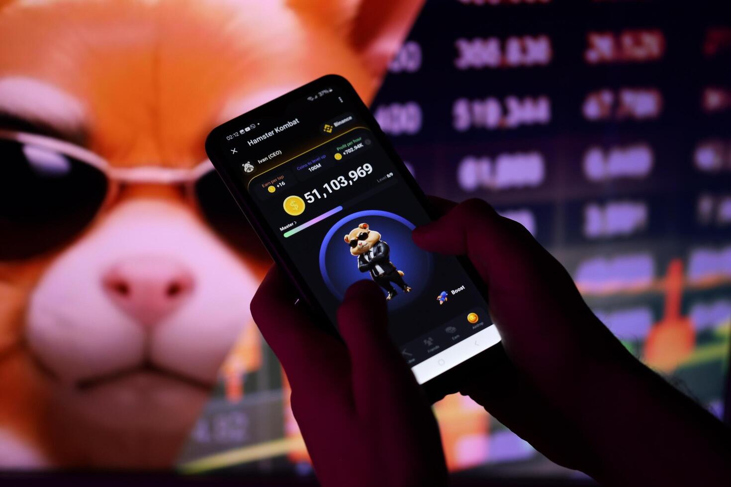 KYIV, UKRAINE - APRIL 20, 2024 Hamster Kombat telegram bot on smartphone screen. Hamster Kombat is a viral Telegram-based crypto game for earn HMSTR tokens by managing virtual crypto exchange photo