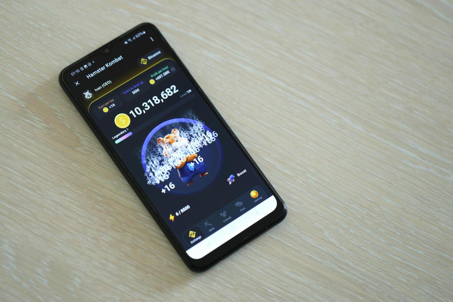 KYIV, UKRAINE - APRIL 20, 2024 Hamster Kombat telegram bot on smartphone screen. Hamster Kombat is a viral Telegram crypto game for earn HMSTR tokens by managing virtual crypto exchange photo