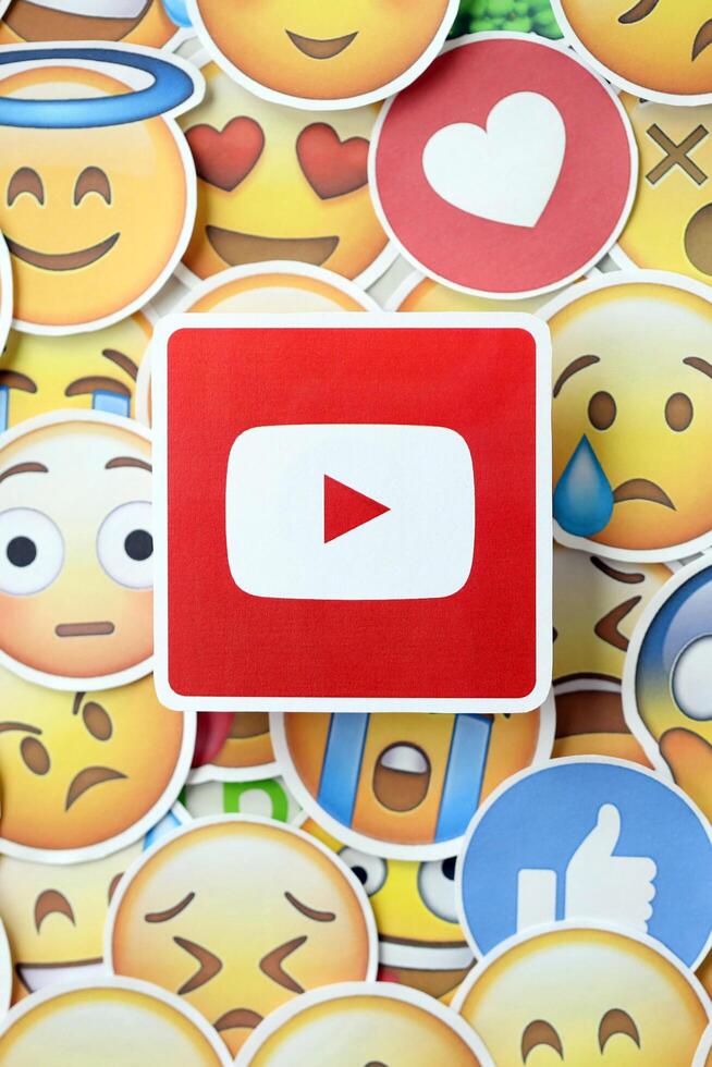 KYIV, UKRAINE - APRIL 20, 2024 YouTube logo and large set of stickers with Emoji yellow faces. Emoji is a pictogram or smiley embedded in text and used in electronic messages photo