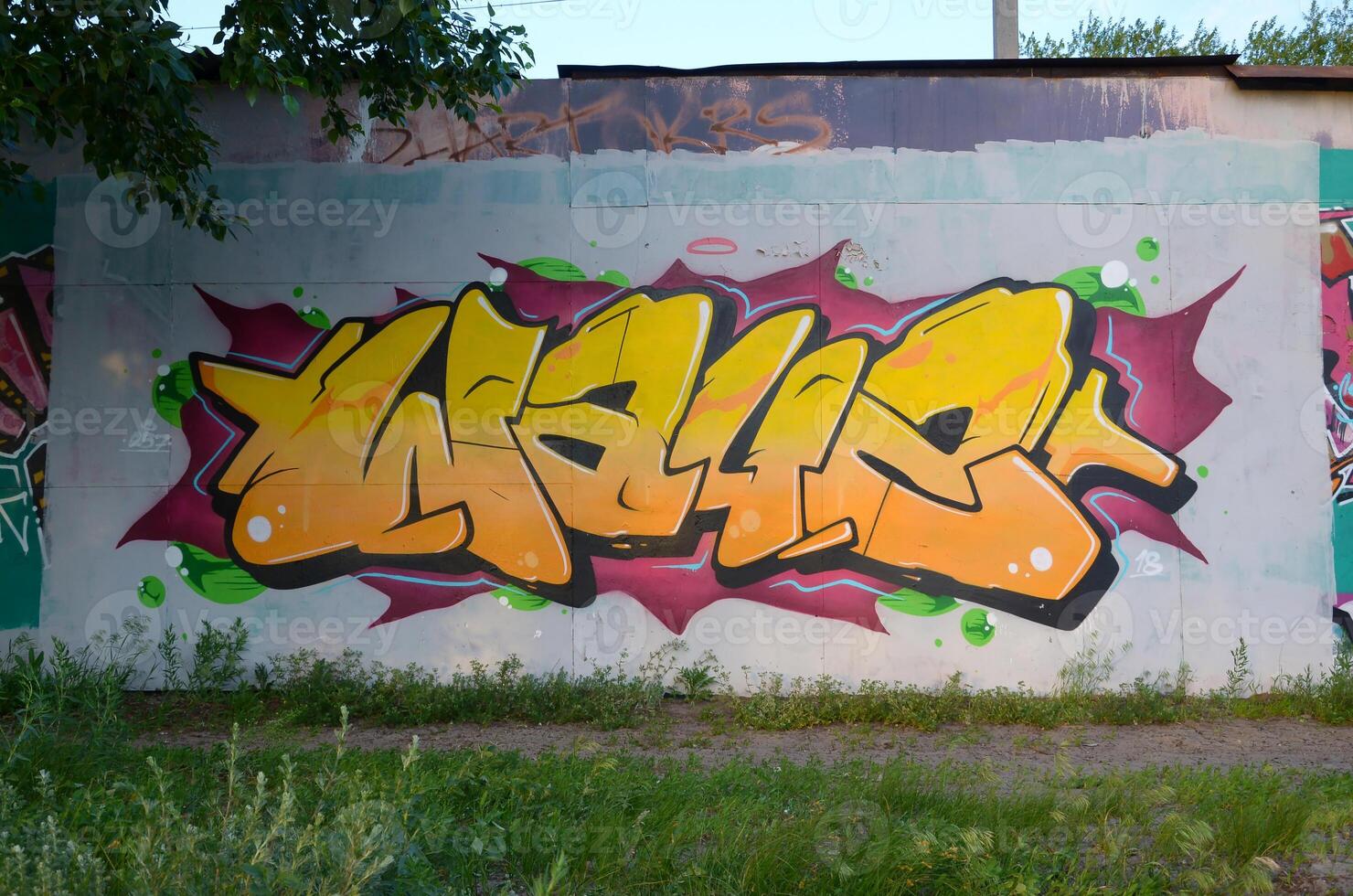 Colorful background of graffiti painting artwork with bright aerosol outlines on wall. Old school street art piece made with aerosol spray paint cans. Contemporary youth culture photo