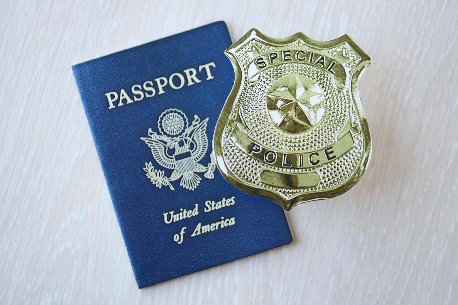 KYIV, UKRAINE - MARCH 9, 2024 US Special Police badge and United States passport on wooden table photo