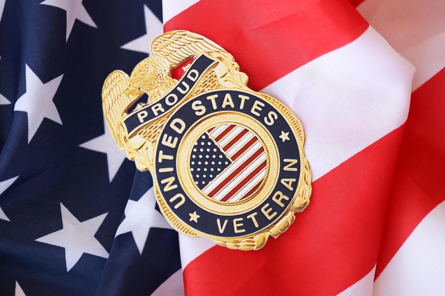 KYIV, UKRAINE - MARCH 9, 2024 US Proud Veteran badge on United States of America flag photo
