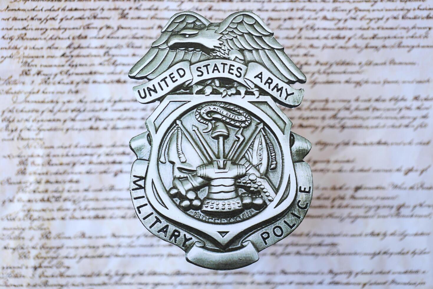 KYIV, UKRAINE - MARCH 9, 2024 US Army Military Police badge on United States Constitution photo