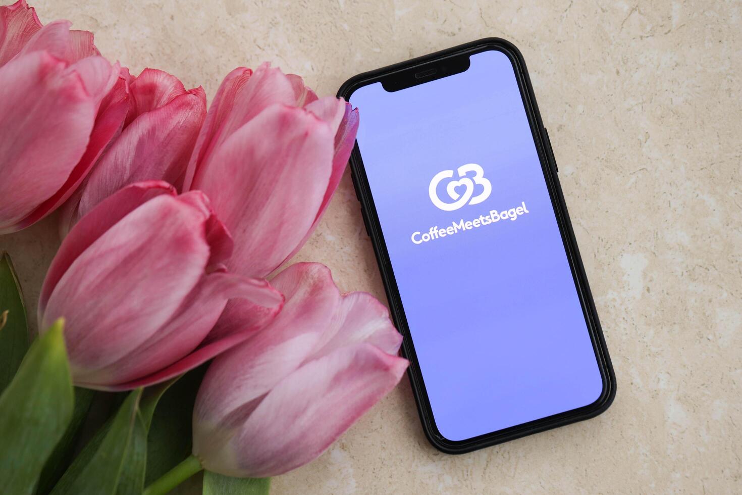 KYIV, UKRAINE - FEBRUARY 23, 2024 CoffeeMeetsBagel logo of famous dating website or app on iPhone display photo