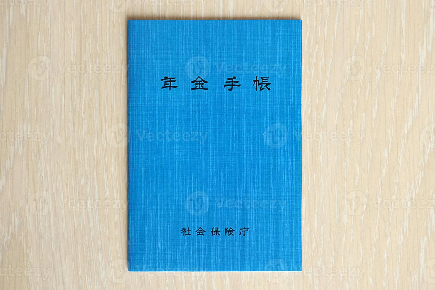 Japanese pension insurance booklet on table. Blue pension book for japan pensioners photo