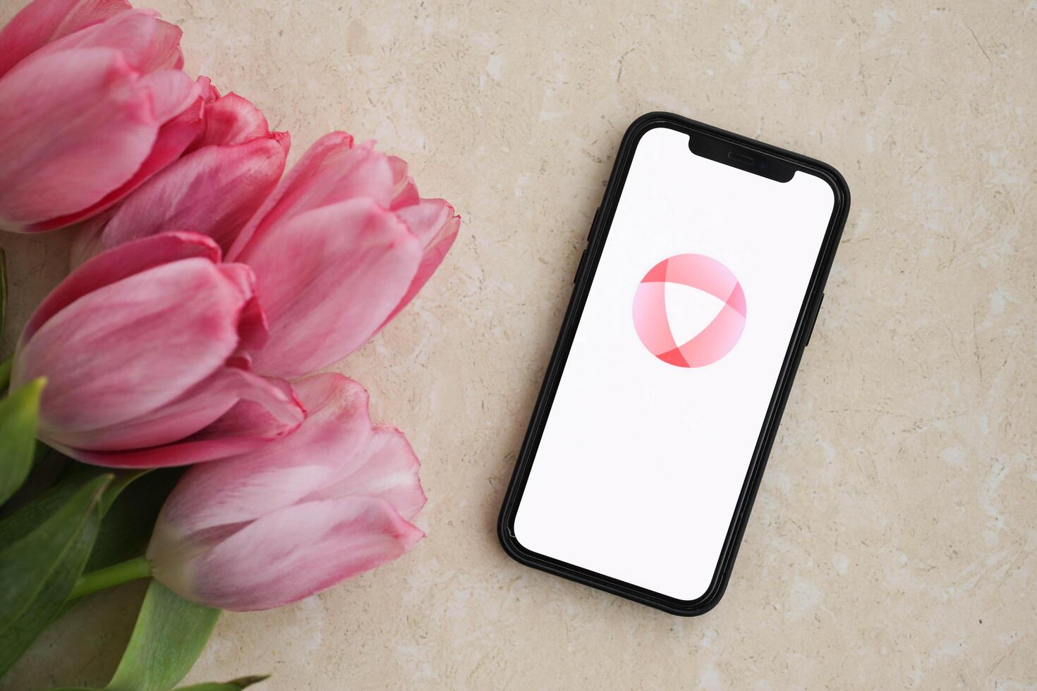 KYIV, UKRAINE - FEBRUARY 23, 2024 Open logo of famous dating website or app on iPhone display photo