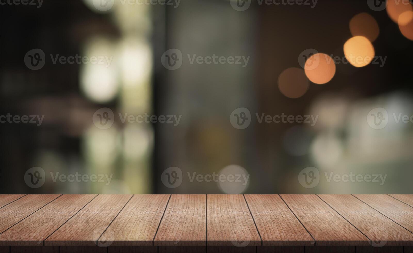 Empty wooden table top with lights bokeh on blur restaurant background. photo