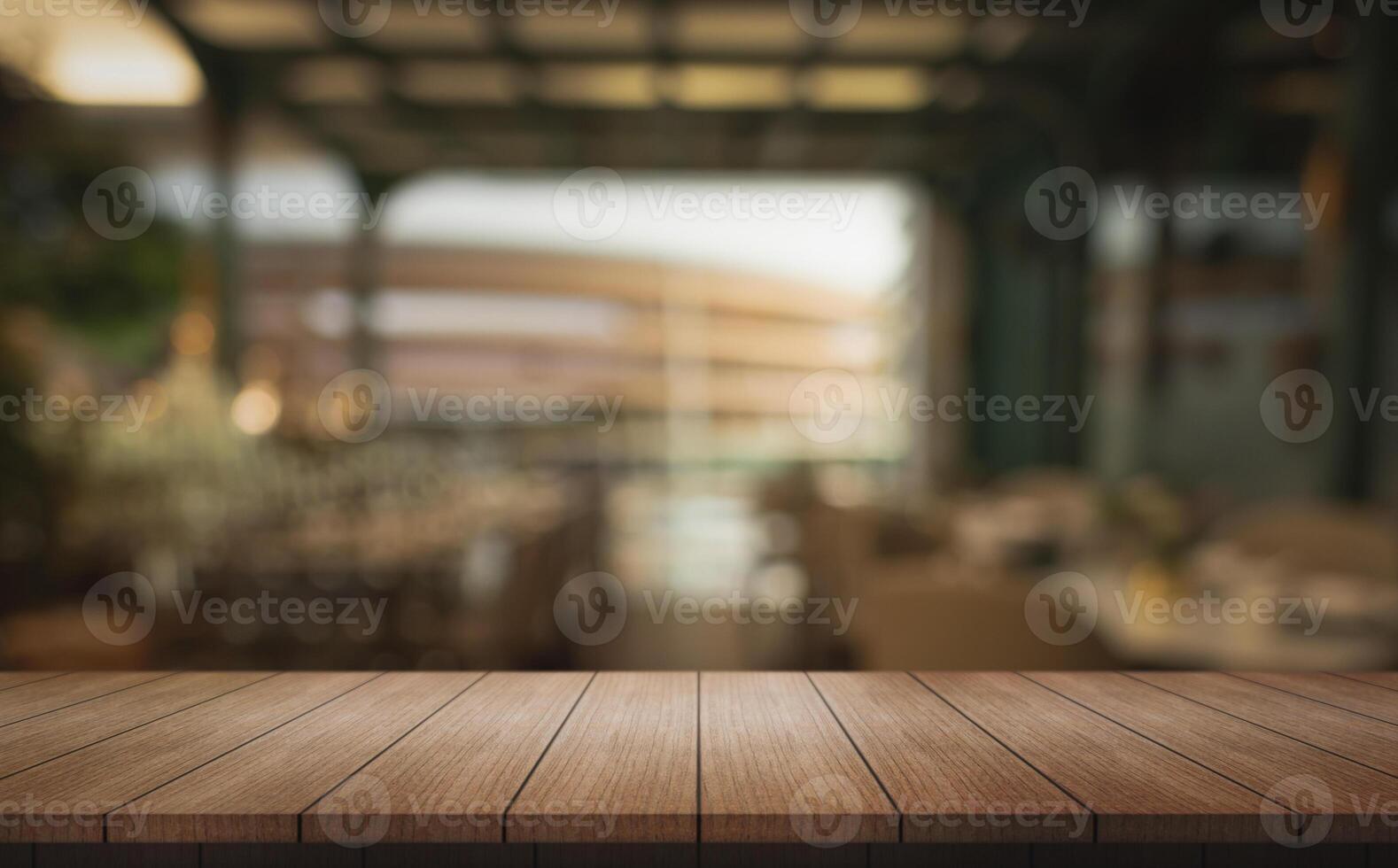Empty wooden table top with lights bokeh on blur restaurant background. photo