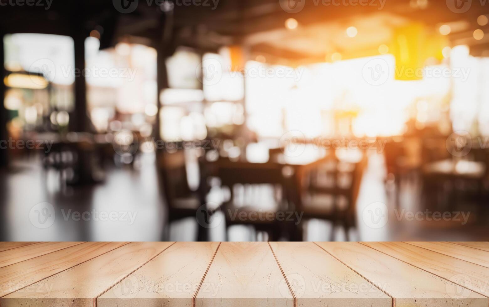 Empty wooden table top with lights bokeh on blur restaurant background. photo
