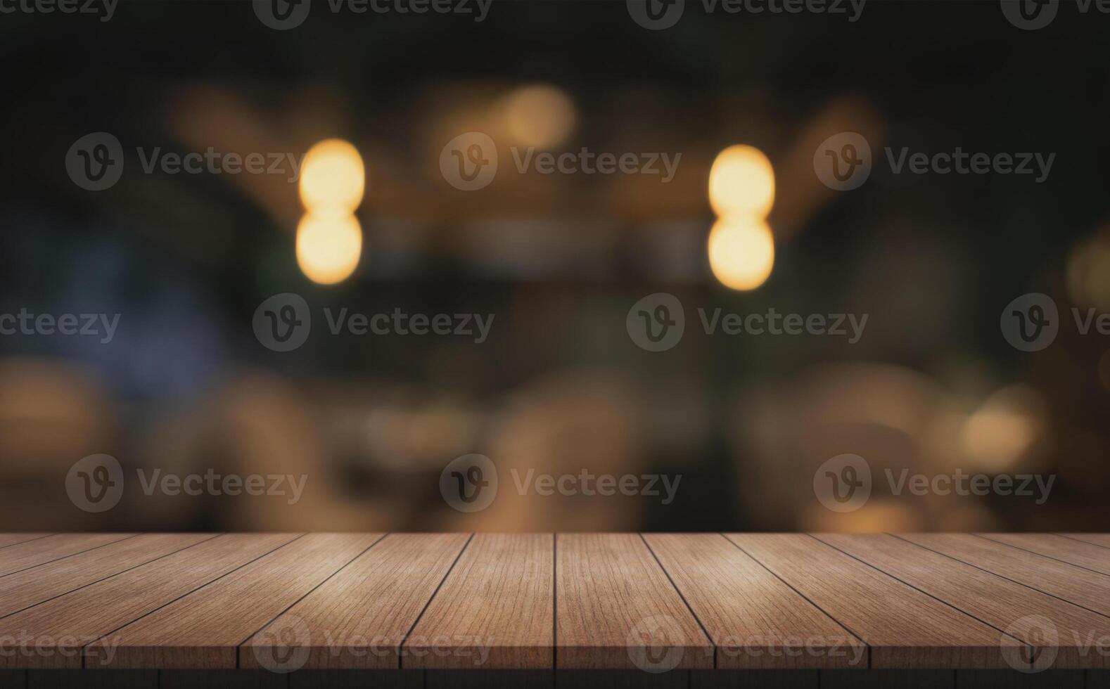 Empty wooden table top with lights bokeh on blur restaurant background. photo