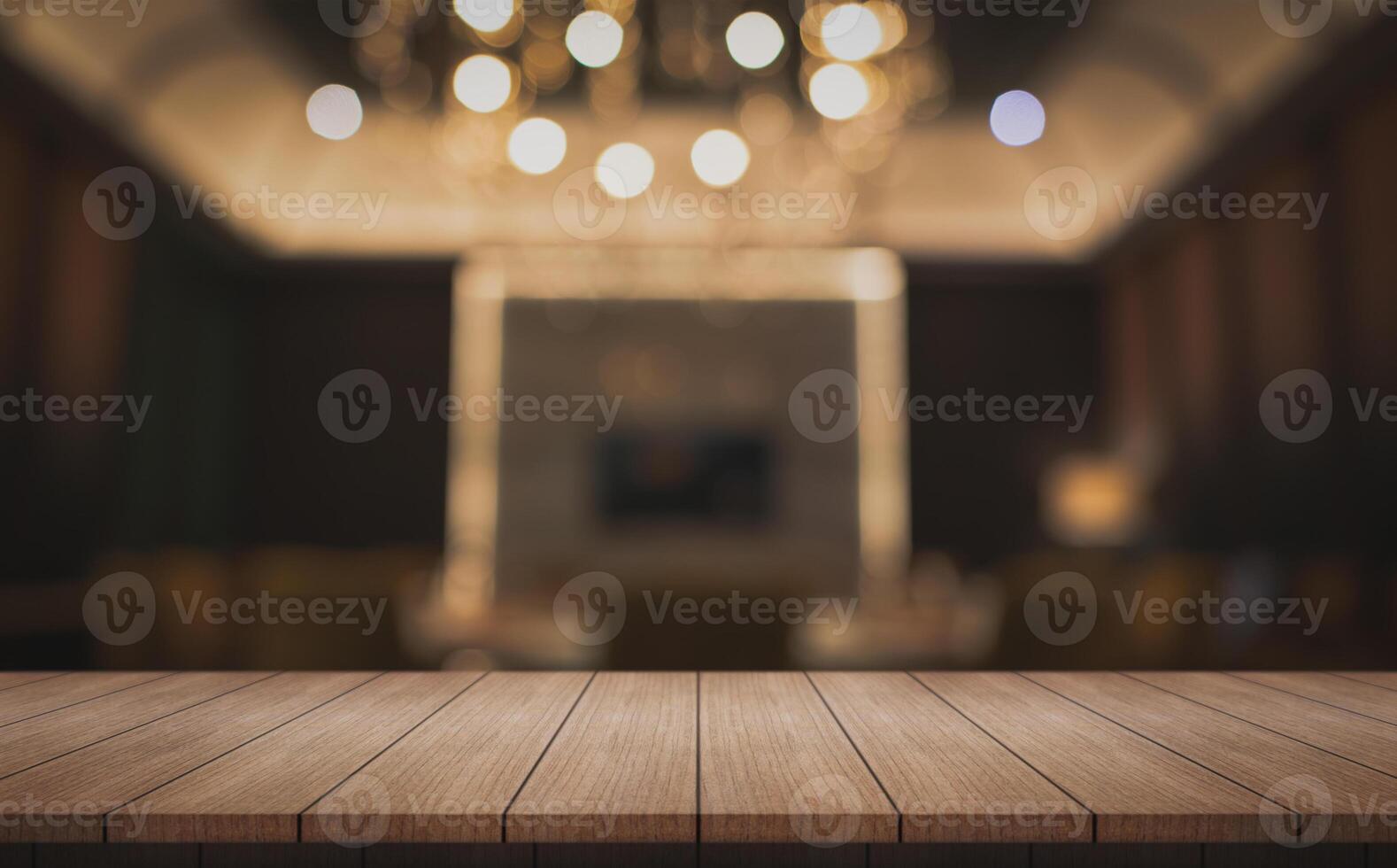 Empty wooden table top with lights bokeh on blur restaurant background. photo