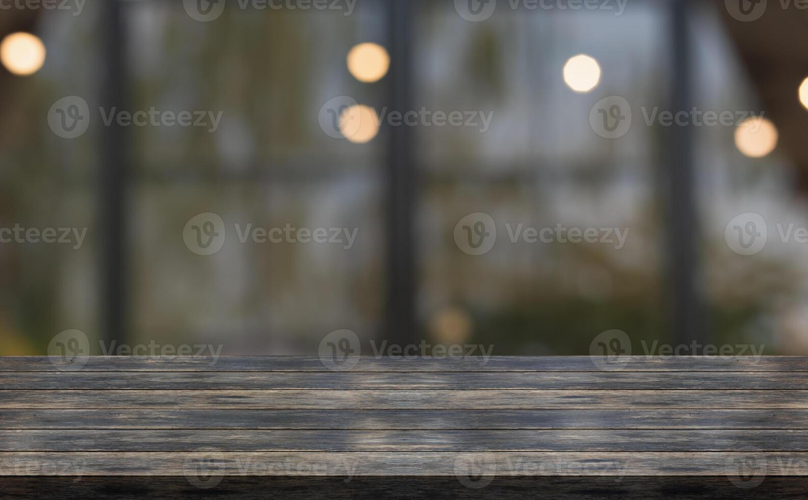 Empty wooden table top with lights bokeh on blur restaurant background. photo