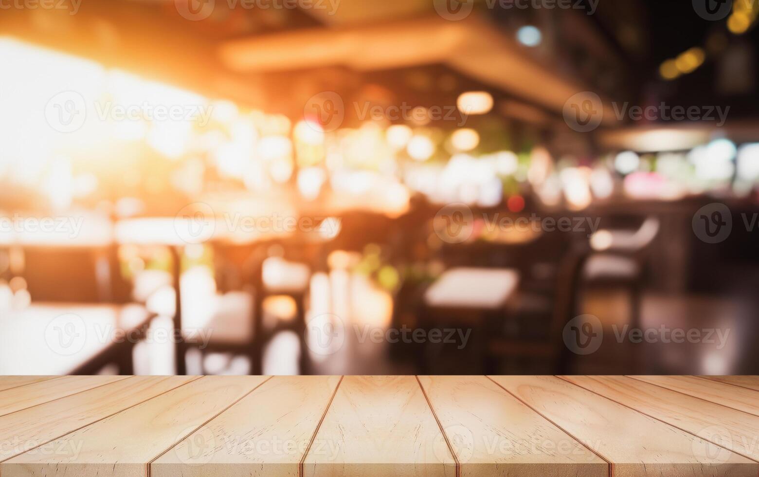 Empty wooden table top with lights bokeh on blur restaurant background. photo