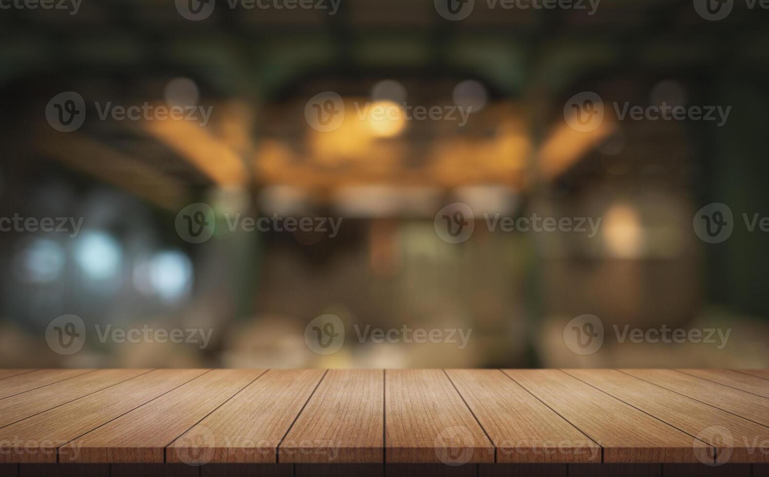 Empty wooden table top with lights bokeh on blur restaurant background. photo