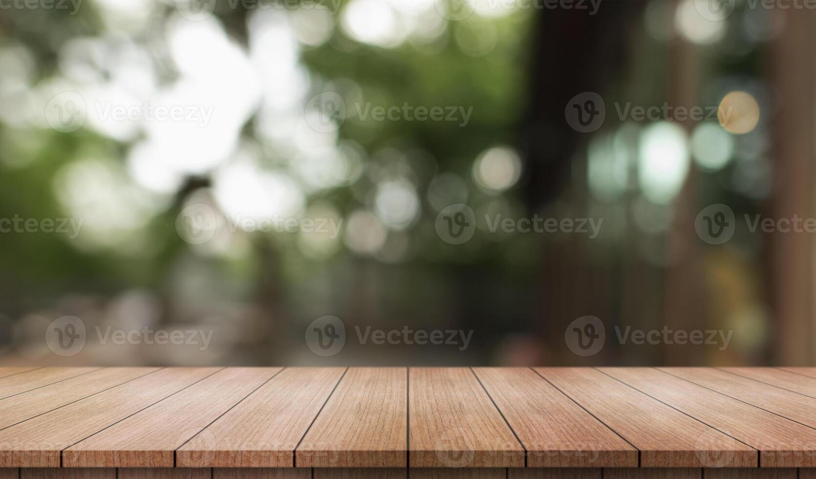 Empty wooden table top with lights bokeh on blur restaurant background. photo