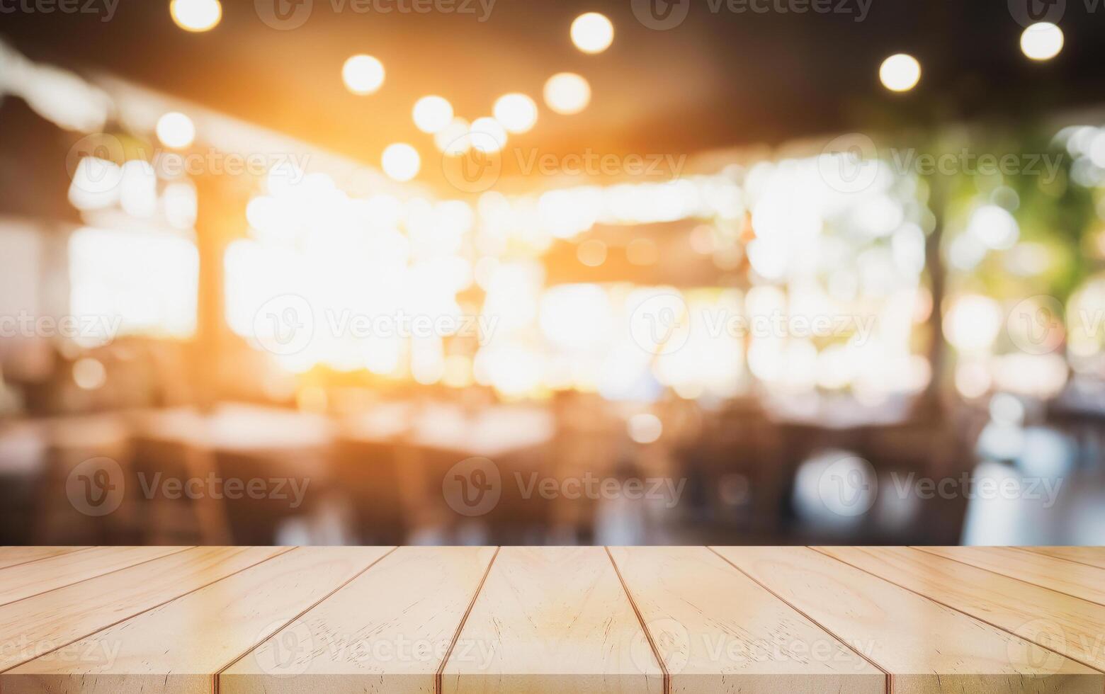 Empty wooden table top with lights bokeh on blur restaurant background. photo
