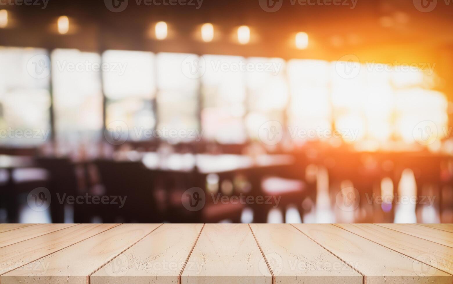 Empty wooden table top with lights bokeh on blur restaurant background. photo