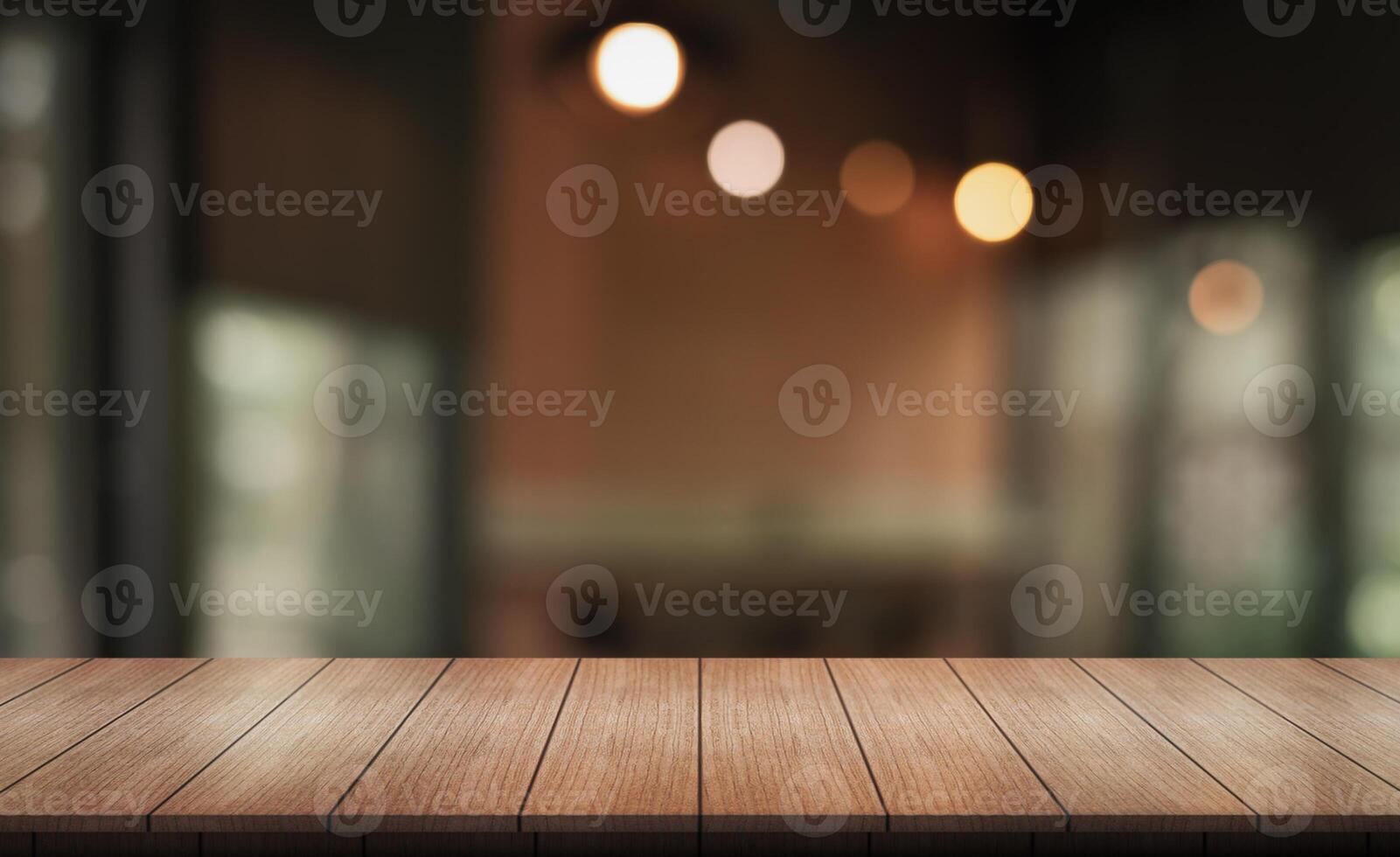 Empty wooden table top with lights bokeh on blur restaurant background. photo