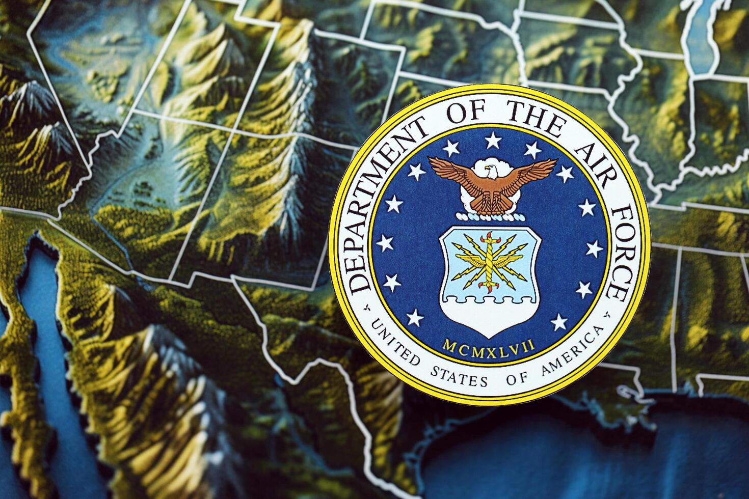 KYIV, UKRAINE - JUNE 26, 2024 United States Department of the Air Force coat of arms on paper map of United States photo