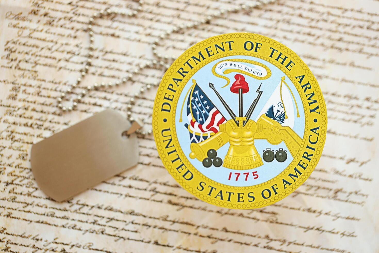 KYIV, UKRAINE - MARCH 9, 2024 US Department of Army seal with dogtags on United States Constitution photo
