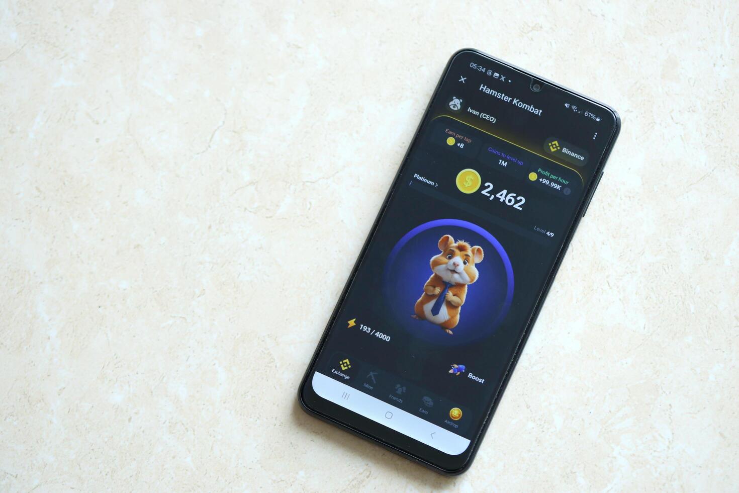 KYIV, UKRAINE - APRIL 20, 2024 Hamster Kombat telegram bot on smartphone screen. Hamster Kombat is a viral Telegram crypto game for earn HMSTR tokens by managing virtual crypto exchange photo