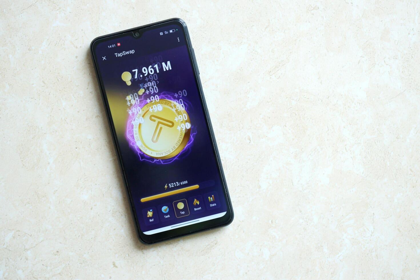 KYIV, UKRAINE - APRIL 20, 2024 Tap Swap telegram bot on smartphone screen. Tap Swap is a viral Telegram based crypto game for earn tokens by managing virtual crypto exchange photo
