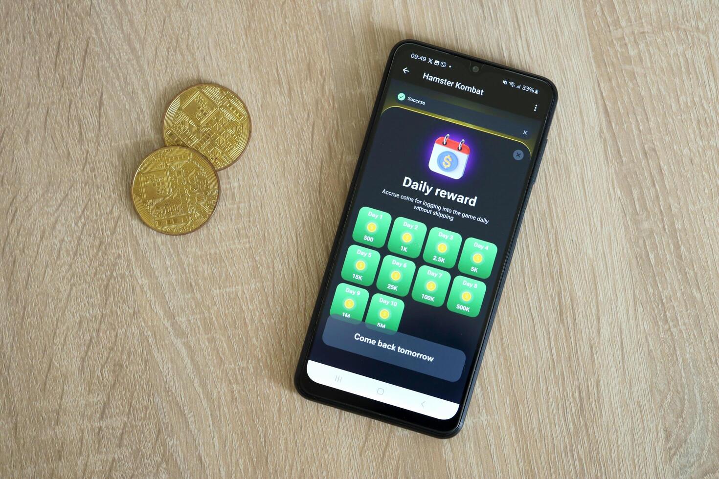 KYIV, UKRAINE - APRIL 20, 2024 Hamster Kombat telegram bot on smartphone screen. Hamster Kombat is a viral Telegram crypto game for earn HMSTR tokens by managing virtual crypto exchange photo