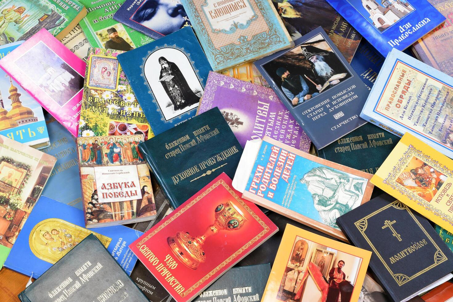 KYIV, UKRAINE - 4 MAY, 2023 Christian slavonic religious book stacked on table in chaotic order photo
