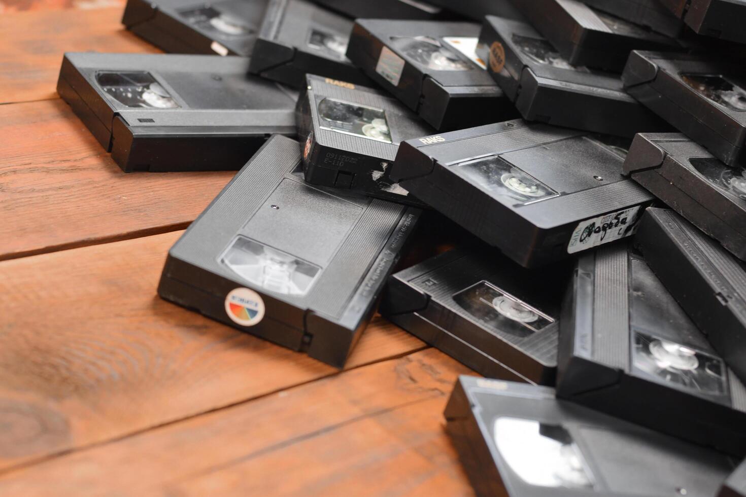 KYIV, UKRAINE - 4 MAY, 2023 tape on colored background, VHS, cassette. Messy stack of VHS tapes. Home System tape photo
