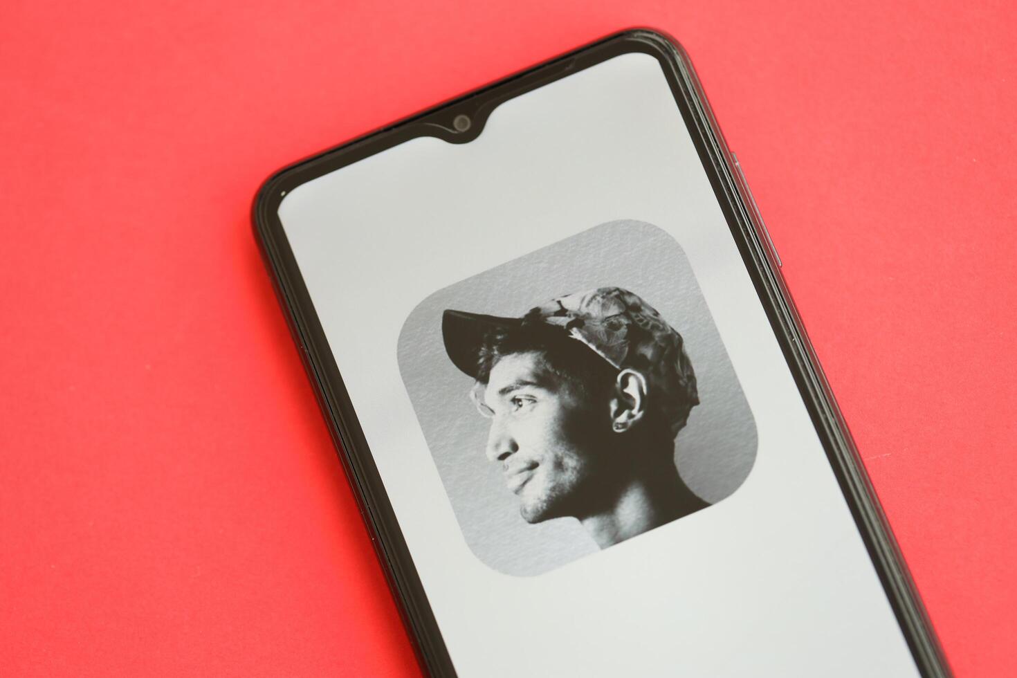 KYIV, UKRAINE - APRIL 1, 2024 Clubhouse icon on smartphone screen on red table photo