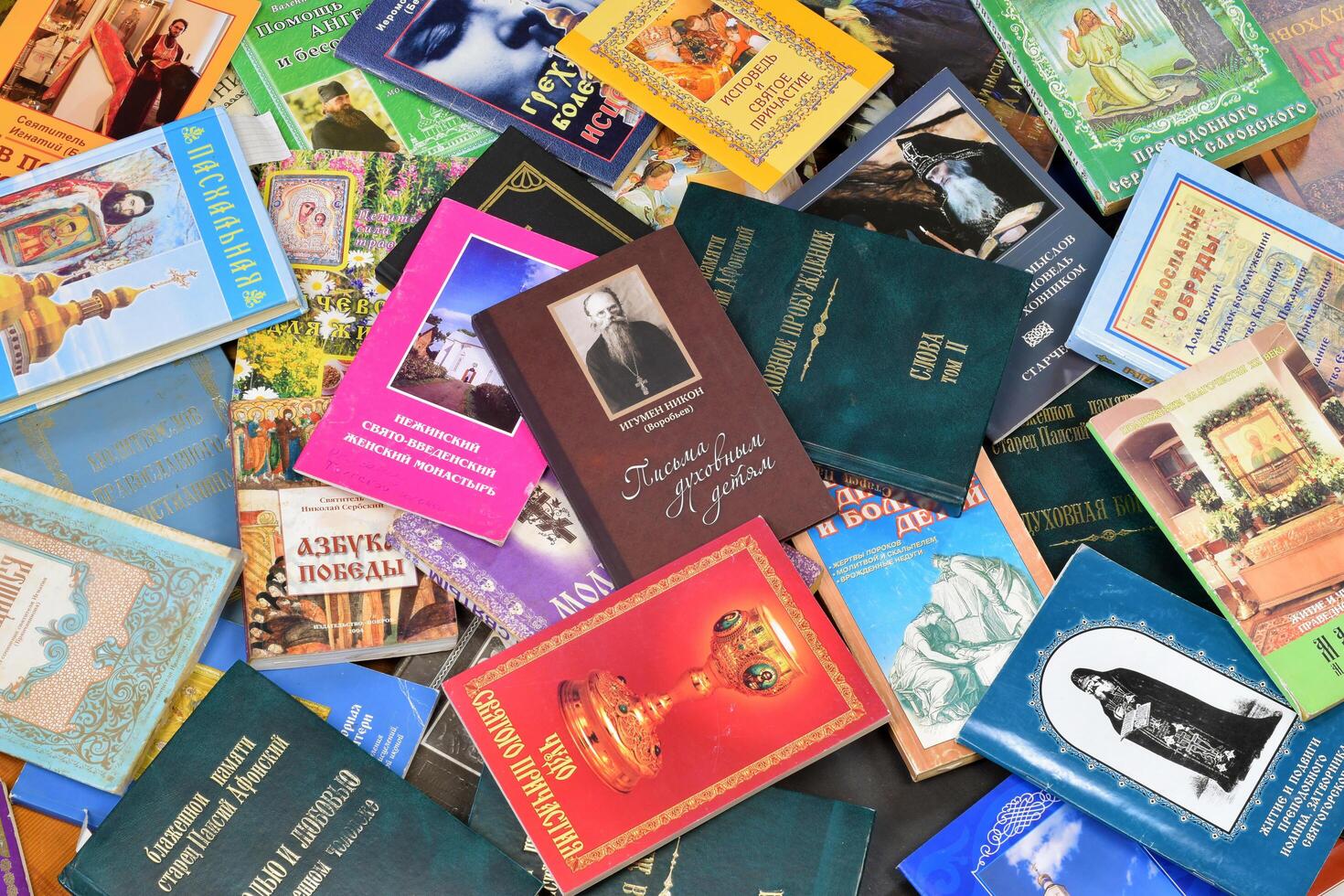 KYIV, UKRAINE - 4 MAY, 2023 Christian slavonic religious book stacked on table in chaotic order photo