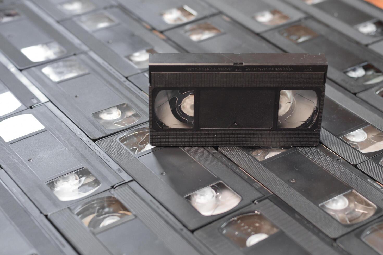 KYIV, UKRAINE - 4 MAY, 2023 tape on colored background, VHS, cassette. Messy stack of VHS tapes. Home System tape photo
