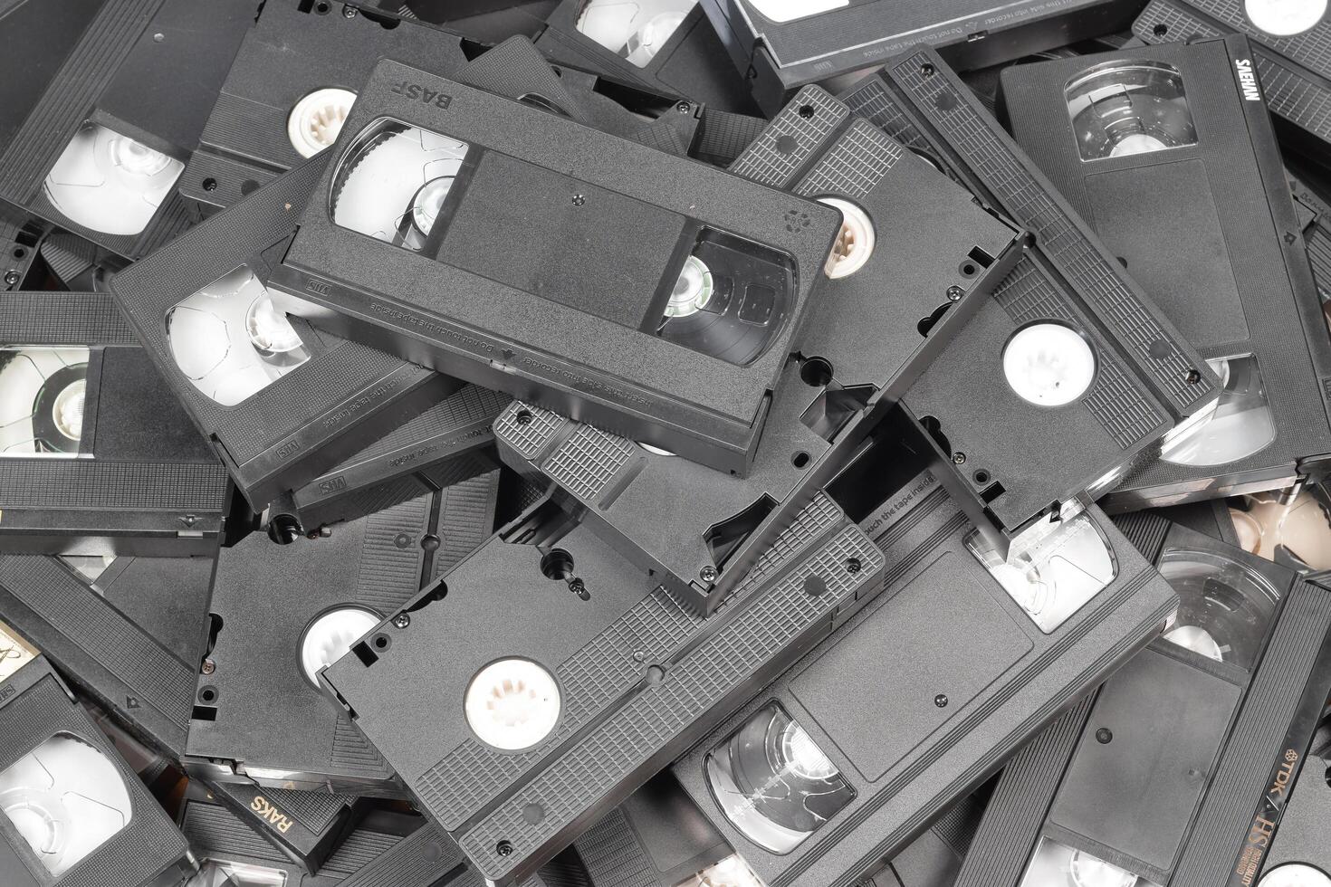 KYIV, UKRAINE - 4 MAY, 2023 tape on colored background, VHS, cassette. Messy stack of VHS tapes. Home System tape photo