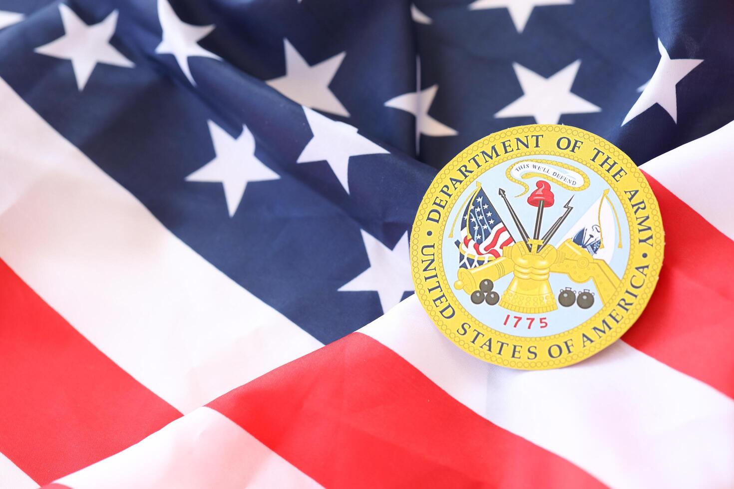 KYIV, UKRAINE - MARCH 9, 2024 US Department of Army seal on United States of America flag photo