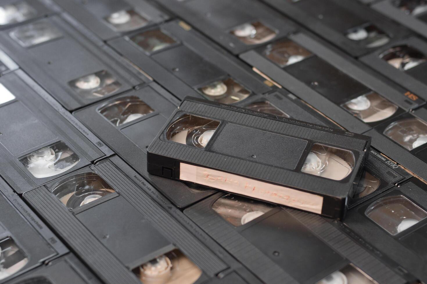 KYIV, UKRAINE - 4 MAY, 2023 tape on colored background, VHS, cassette. Messy stack of VHS tapes. Home System tape photo