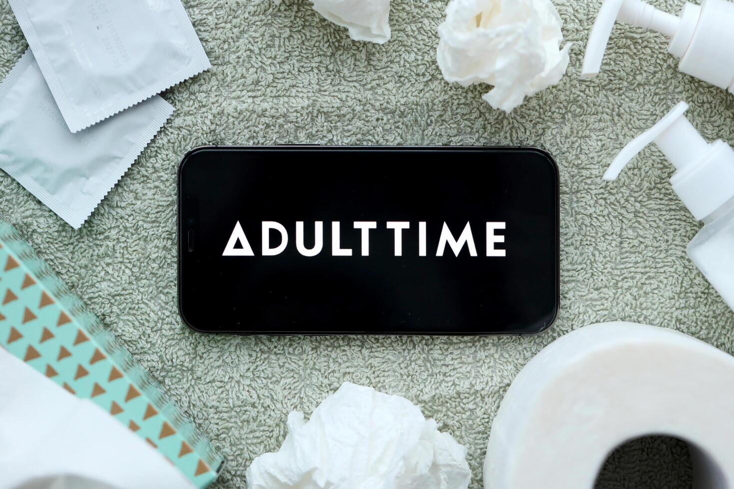 KYIV, UKRAINE - JANUARY 23, 2024 AdultTime adult content website logo on display of iPhone 12 Pro photo