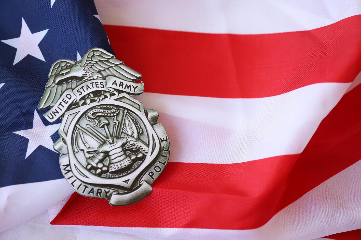 KYIV, UKRAINE - MARCH 9, 2024 US Army Military Police badge on United States of America flag photo