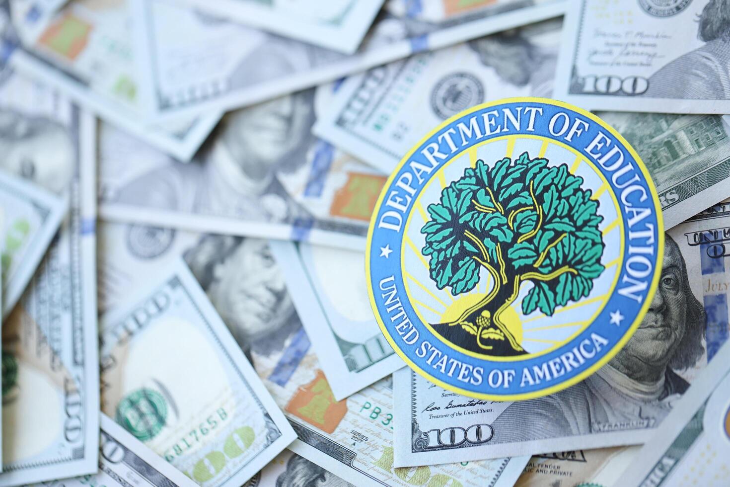 KYIV, UKRAINE - MARCH 9, 2024 US Department of Education seal on many US hundred dollar bills photo