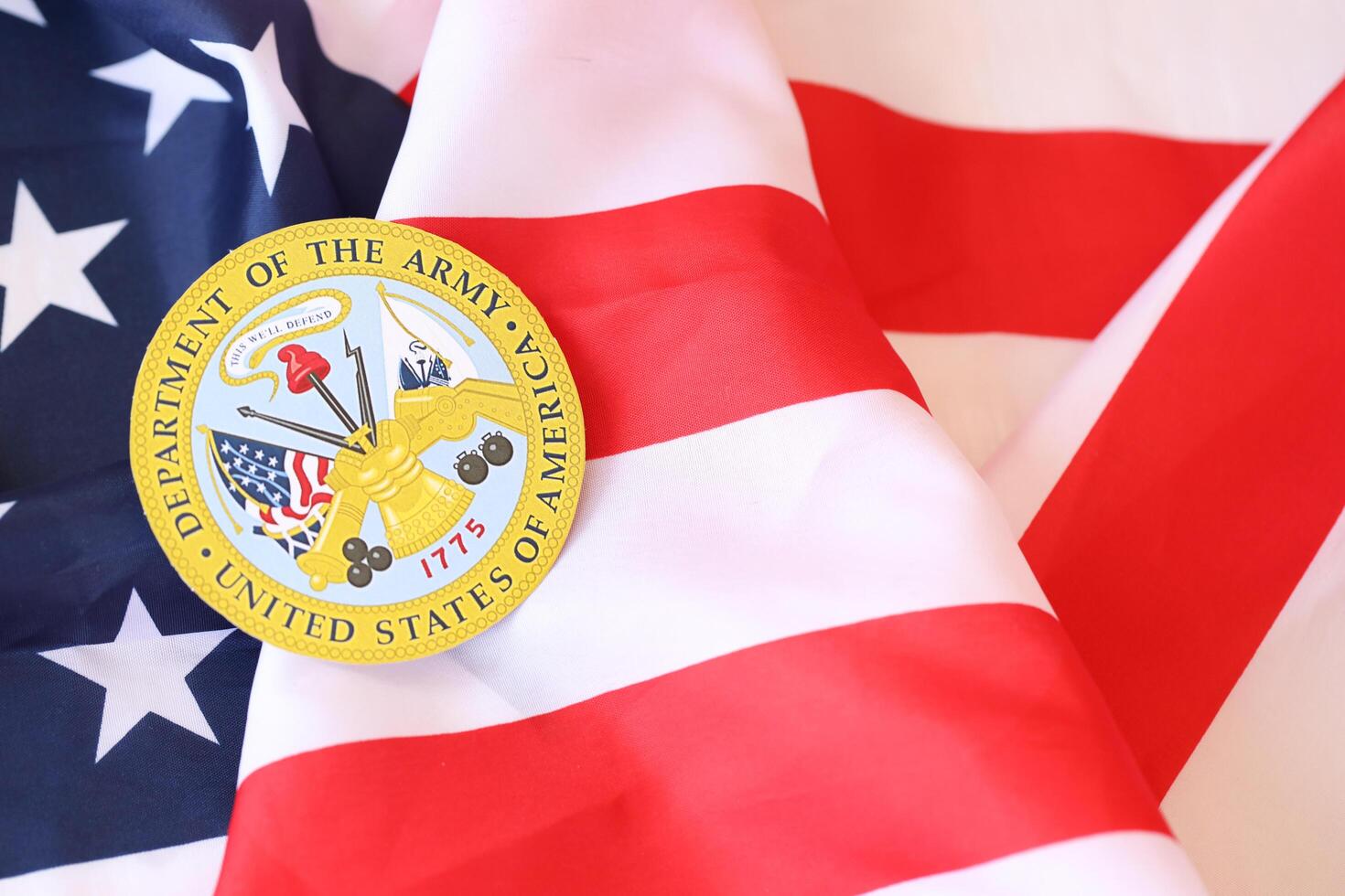 KYIV, UKRAINE - MARCH 9, 2024 US Department of Army seal on United States of America flag photo