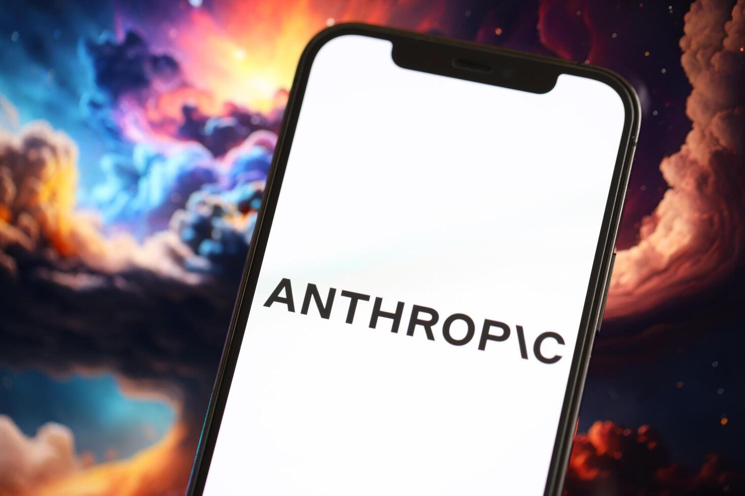 KYIV, UKRAINE - MARCH 17, 2024 Anthropic logo on iPhone display screen with background of artificial intelligence futuristic image photo