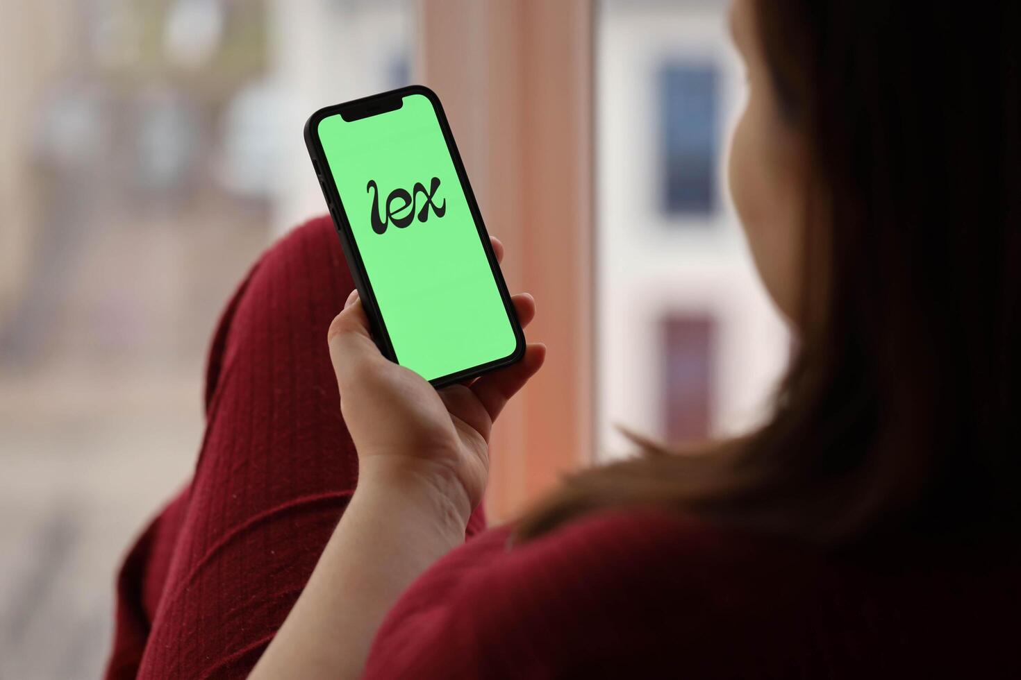 KYIV, UKRAINE - FEBRUARY 23, 2024 Lex logo of famous dating website or app on iPhone display photo