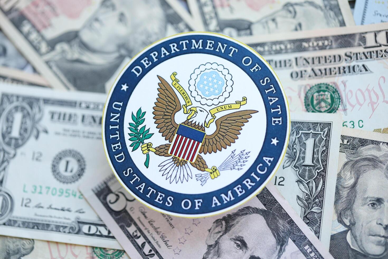 KYIV, UKRAINE - MARCH 9, 2024 US Department of State seal on many US dollar bills photo