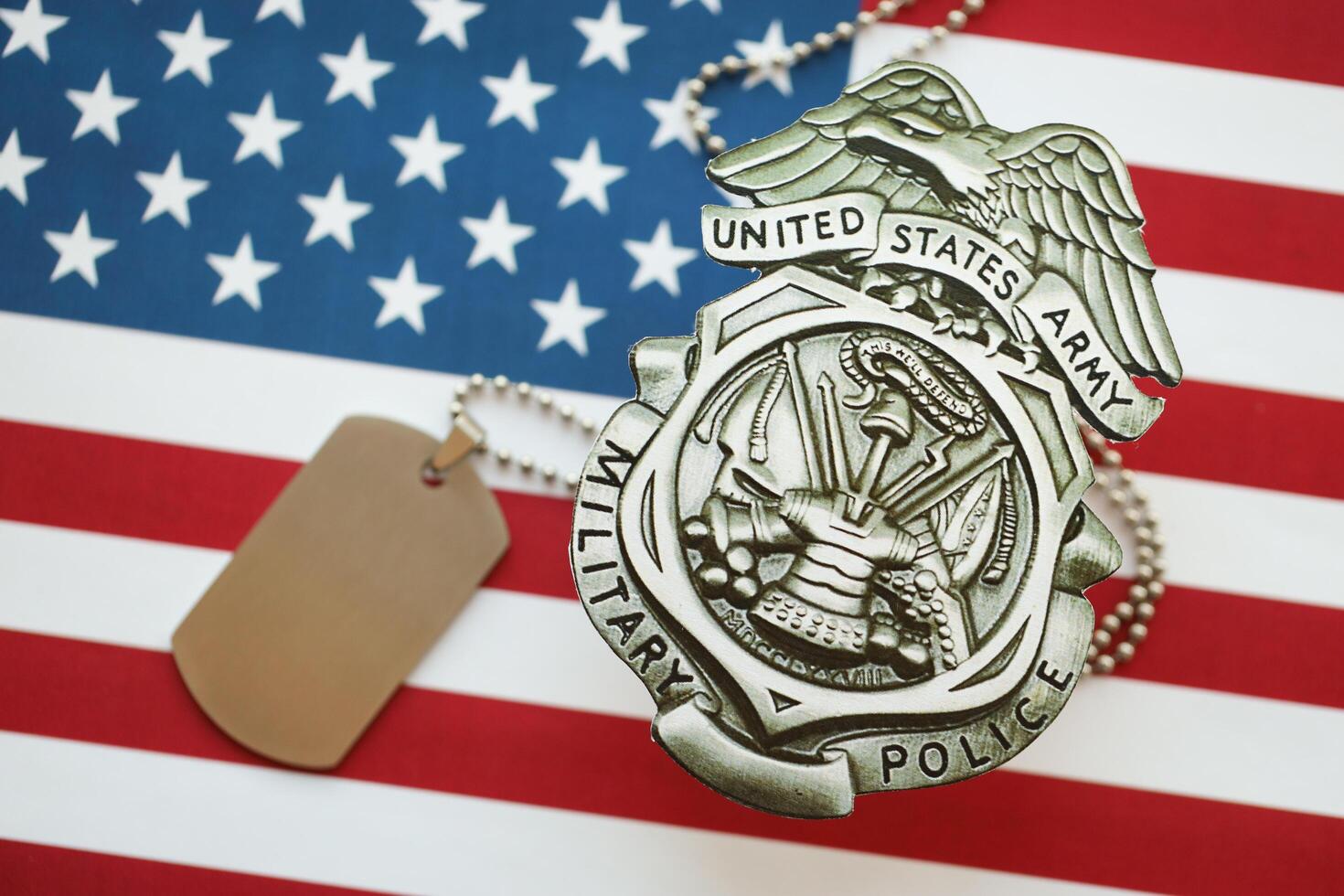 KYIV, UKRAINE - MARCH 9, 2024 US Army Military Police badge with dogtags on United States of America flag photo