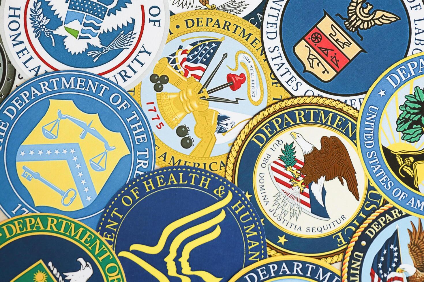 KYIV, UKRAINE - MARCH 9, 2024 Seals of United States of America Departments printed on paper photo