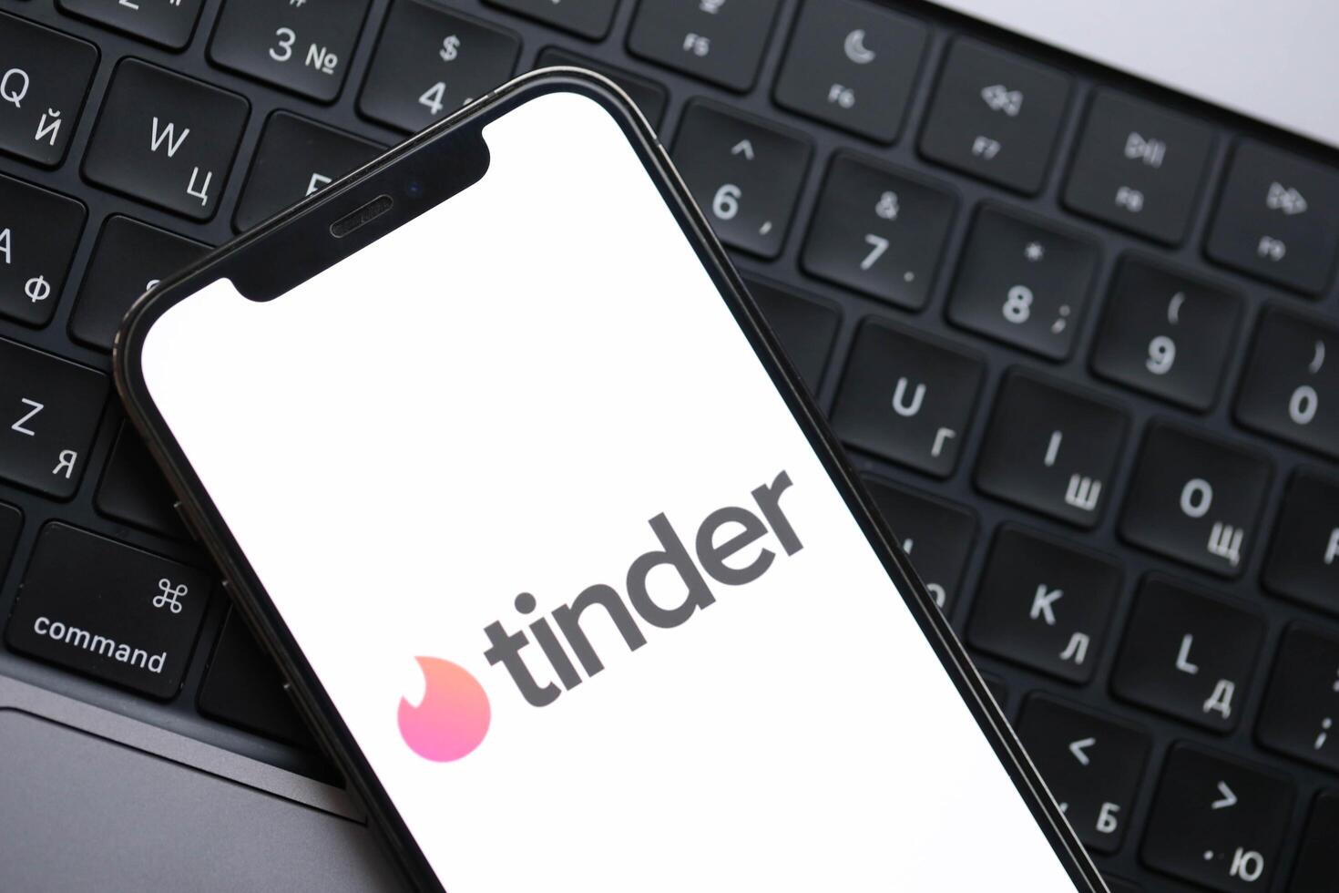 KYIV, UKRAINE - FEBRUARY 23, 2024 Tinder logo of famous dating website or app on iPhone display photo
