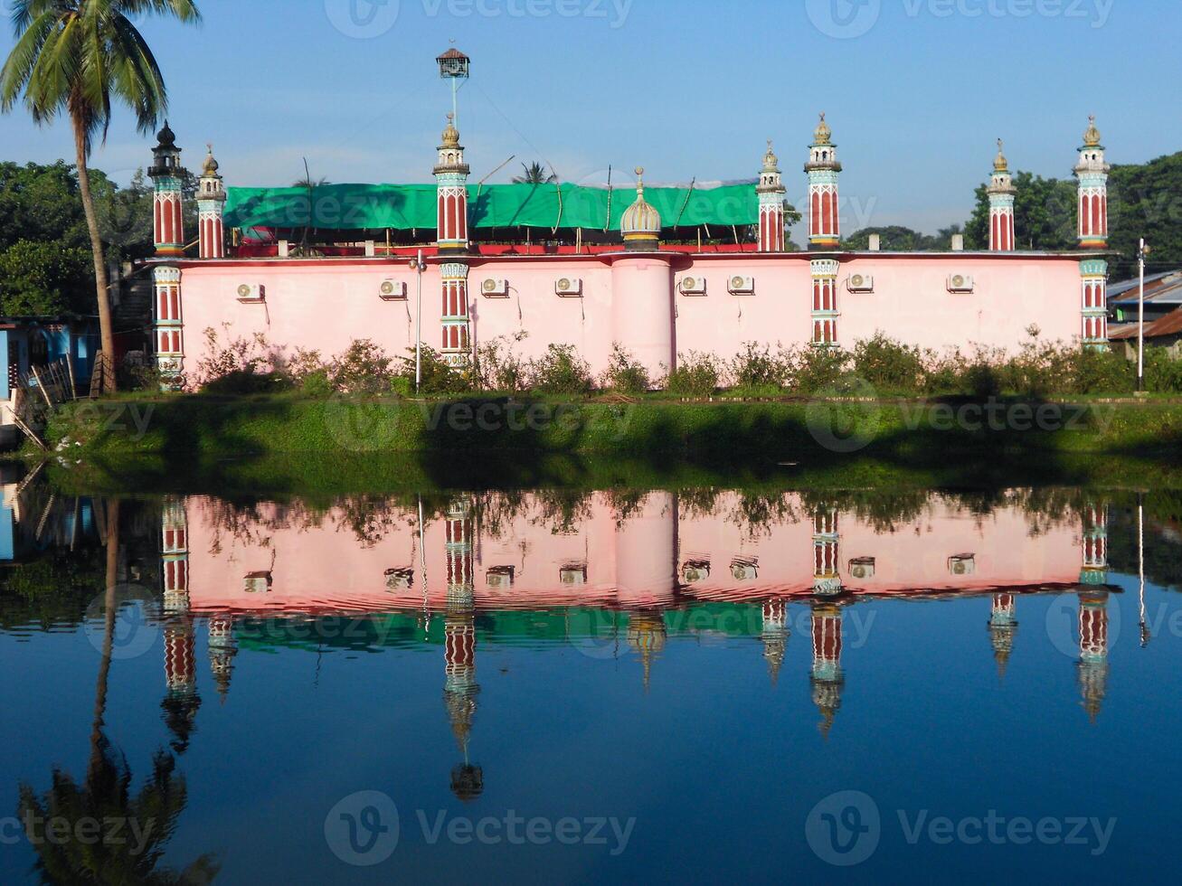 The reflect of a mosque falls on the water photo