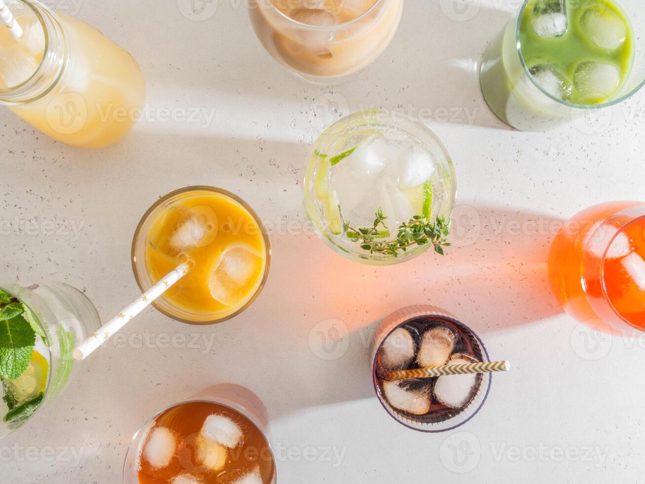 Various refreshing non-alcoholic drinks in glasses with ice photo