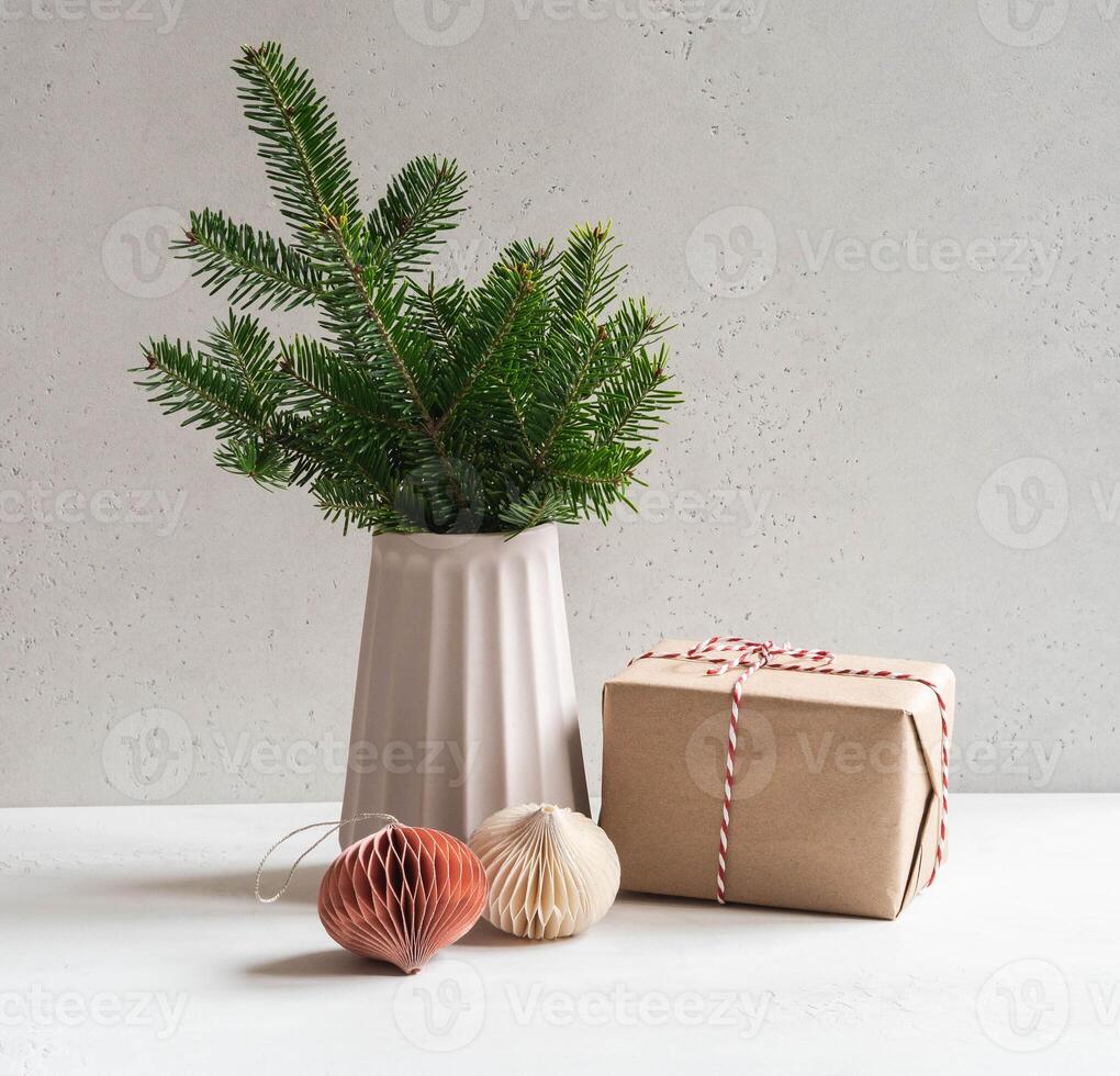 Fir branch in vase and Christmas gift photo