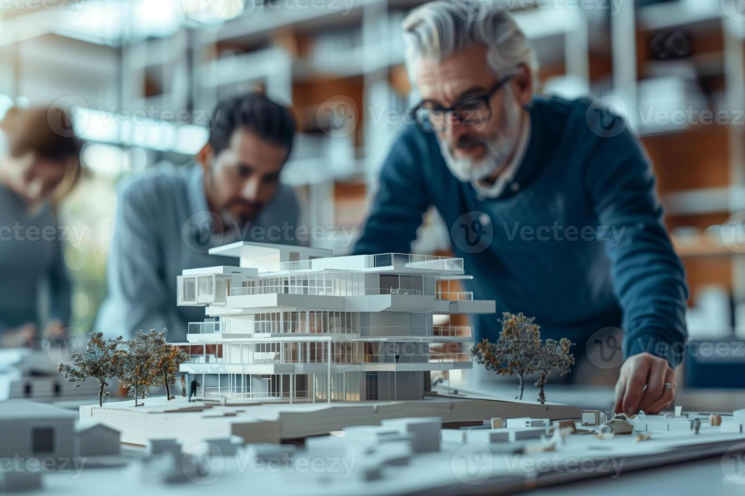A group of architects work together on a detailed model of a city building. They are focused on their project in a modern office space, with a focus on sustainable design photo