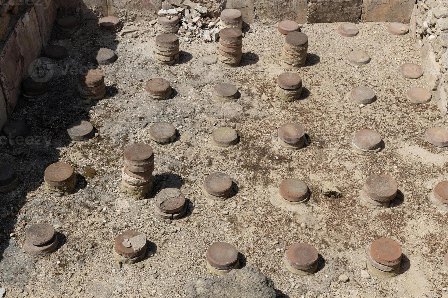 Remains of ancient stone artifacts, baths in the Archaeological Park of Paphos, Cyprus photo